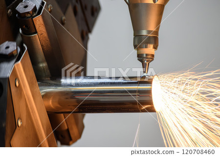 Close up scene the fiber laser cutting machine cut the stainless steel tube and sparkling light. 120708460