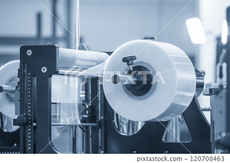 The operation of automatic plastic film production machine with lighting effect. 120708463