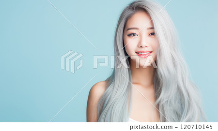 Portrait of smiling asian teenager girl with long and white hair blue background. 120710145