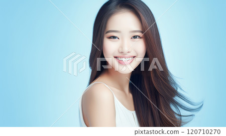 Portrait of smiling asian teenager girl blue background. 120710270