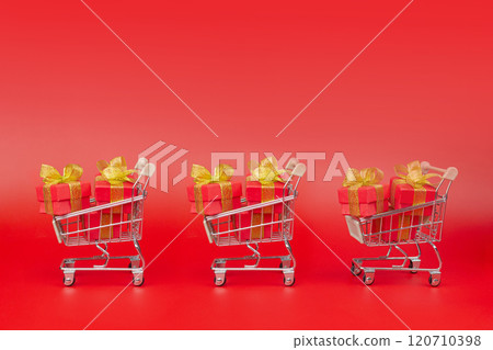 Supermarket trolley, with gifts, purchases. Sale, Discounts, Black Friday, New Year, Christmas, Birthday and Valentines day. Copy space banner Supermarket trolley, with gifts, purchases. Sale, Discounts, Black Friday, New Year, Christmas, Birthday and Valentines day. Copy space banner 120710398