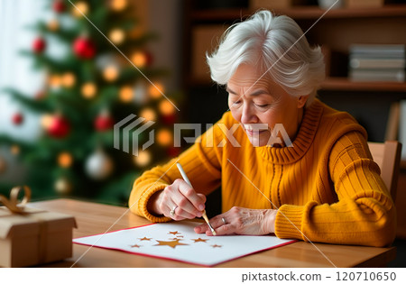 Senior Japanese woman makes Christmas-themed applique for gift for her grandchildren. Gold stars. Handmade. DIY Senior Japanese woman makes Christmas-themed applique for gift for her grandchildren. Gold stars. Handmade. DIY 120710650