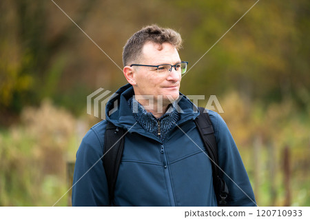 Outdoor portrait of a 45 yo white hiking man in an autumn forest in Oud Heverlee, Belgium 120710933