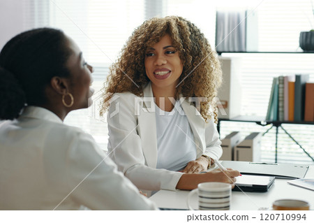 Businesswomen Engaging in Office Discussion 120710994