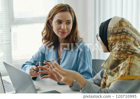 Collaborating with Colleague in Modern Office Setting 120710995