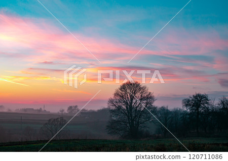 sunset in the field. beautiful autumn foggy landscape in Ukraine 120711086