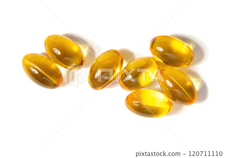 Golden Gelatin Capsules Arranged on a Clean White Surface Showcasing Their Smooth Texture 120711110