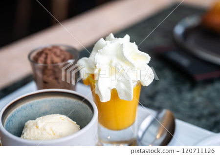 Coffee served with sweet dessets like a cake, vanilla ice scoop and custard in Belgium Coffee served with sweet dessets like a cake, vanilla ice scoop and custard in Belgium 120711126