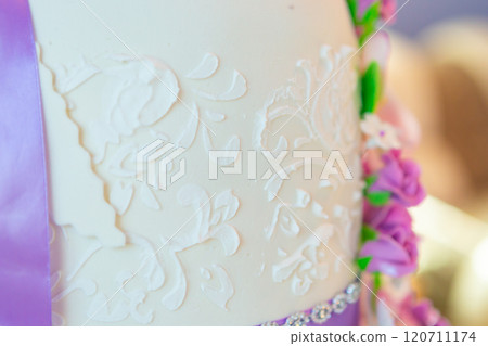 wedding cake decoration. beautiful wedding cake with purple orchids. cake in violet tones 120711174