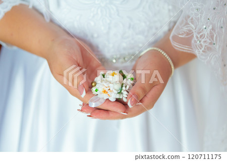 Bride's hands with a bouquet for the groom. place for text 120711175
