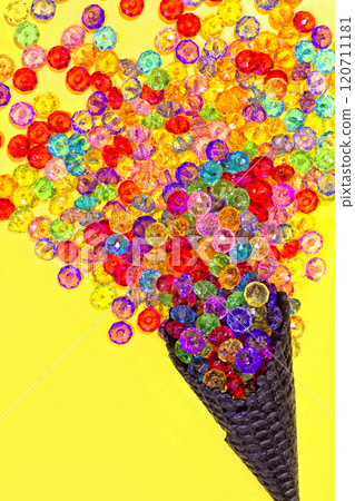 ice cream cone with multicolored beads on a yellow background 120711181