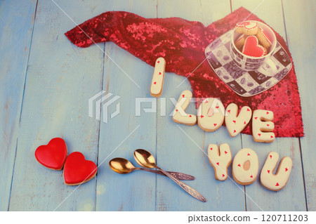 Homemade cookies in the form of a heart or I love you words on Valentine's Day on a blue board top view Homemade cookies in the form of a heart or I love you words on Valentine's Day on a blue board top view 120711203