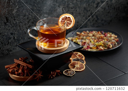 Cup of herbal tea with ingredients and slices of dried orange slices. Cup of herbal tea with ingredients and slices of dried orange slices. 120711632