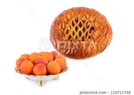 Ripe juicy apricots in a vintage porcelain fruit bowl and Homemade fruit pie isolated on white. Collage. Free space for text. Ripe juicy apricots in a vintage porcelain fruit bowl and Homemade fruit pie isolated on white. Collage. Free space for text. 120711788