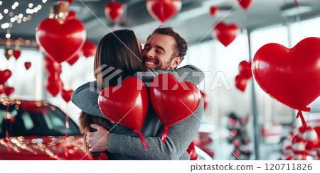 Happy couple in dealership store salon. Surprise buy new car luxury automobile Valentine day present gift with red balloon, buying auto shock happy amazed wife hug husband Happy couple in dealership store salon. Surprise buy new car luxury automobile Valentine day present gift with red balloon, buying auto shock happy amazed wife hug husband 120711826