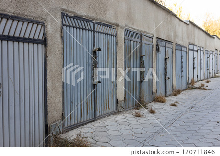 Lots of metal garage doors. Entrances to parking spaces in courtyard of building Lots of metal garage doors. Entrances to parking spaces in courtyard of building 120711846