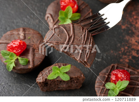 Freshly baked chocolate brownies decorated with sweet cherries and sprigs of mint Freshly baked chocolate brownies decorated with sweet cherries and sprigs of mint 120711889