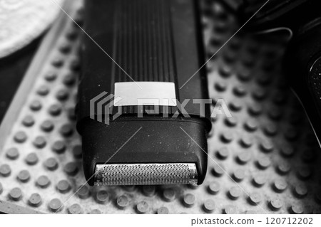 Close-up view of a vintage electric razor on a textured surface Close-up view of a vintage electric razor on a textured surface 120712202