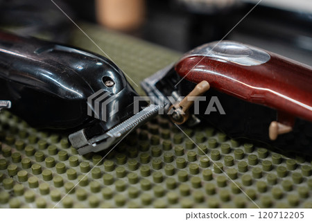 Hair clippers resting on a textured surface in a barber shop setting 120712205