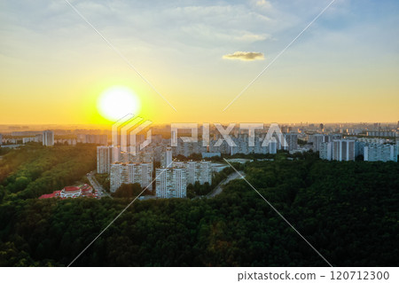 Stunning sunset over a vibrant urban skyline surrounded by lush greenery Stunning sunset over a vibrant urban skyline surrounded by lush greenery 120712300