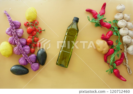 A variety of Colorful Vegetables and a drizzle of Olive Oil beautifully arranged on a Wooden Surface A variety of Colorful Vegetables and a drizzle of Olive Oil beautifully arranged on a Wooden Surface 120712460