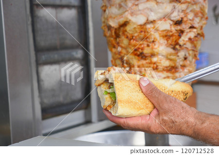 Indulge in a Delicious Shawarma Sandwich crafted with the freshest and finest ingredients 120712528