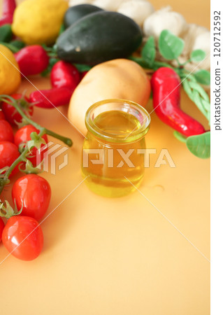 Vibrant fresh vegetables arranged beautifully with olive oil on a bright background 120712592