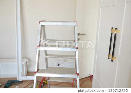 The Complete Home Renovation Process Happening with Ladder and Tools in a Room Setting 120712755
