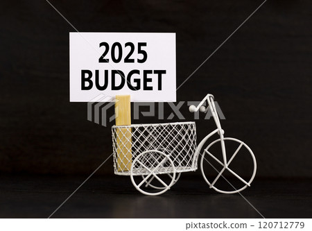 Planning 2025 budget new year symbol. Concept words 2025 Budget on beautiful white paper on wooden clothespin. Bicycle. Beautiful black background. Business 2025 budget new year concept. Copy space. Planning 2025 budget new year symbol. Concept words 2025 Budget on beautiful white paper on wooden clothespin. Bicycle. Beautiful black background. Business 2025 budget new year concept. Copy space. 120712779