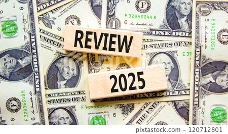 Planning review 2025 new year symbol. Concept words Review 2025 on beautiful wooden blocks. Dollar bills. Beautiful background from dollar bills. Business review 2025 new year concept. Copy space. 120712801