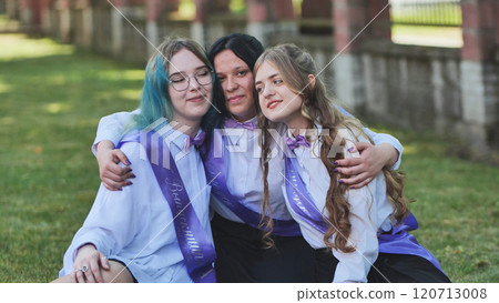 Three happy graduates in sashes share a heartfelt goodbye on their last day of school, celebrating academic success with joy and excitement Three happy graduates in sashes share a heartfelt goodbye on their last day of school, celebrating academic success with joy and excitement 120713008
