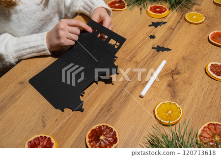 Gingerbread paper house handmade Storytelling creating craft Christmas holiday decoration. Tactile hand-on activity. Master class progress of creative me-made gifts. Seasonal domestic life micro Gingerbread paper house handmade Storytelling creating craft Christmas holiday decoration. Tactile hand-on activity. Master class progress of creative me-made gifts. Seasonal domestic life micro 120713618