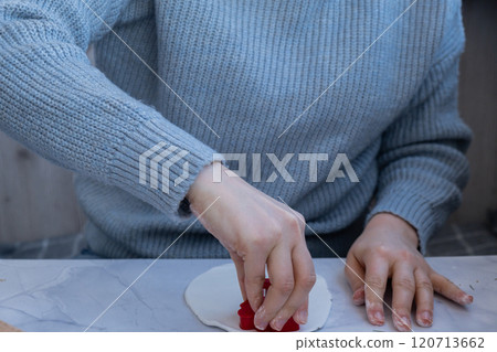 Workshop cutting figures Creator is using white air dry clay for making decor to Christmas tree holiday. Creating hobby recreation activity that involves fingers. DIY crafting 120713662