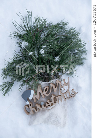 Reusable shopping bag with fir spruce green branches in snowy outdoor winter forest background. Merry Christmas wooden message and new year concept. Natural bouquet greeting card copy space Reusable shopping bag with fir spruce green branches in snowy outdoor winter forest background. Merry Christmas wooden message and new year concept. Natural bouquet greeting card copy space 120713673