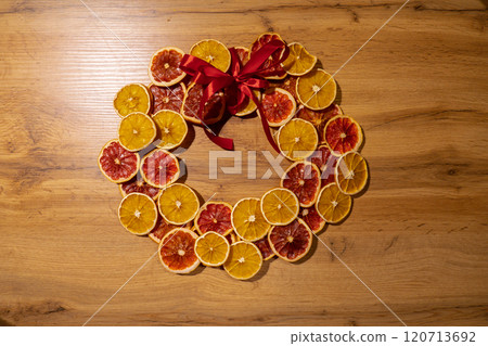 DIY process of woman making Christmas arrangement with dried oranges and grapefruits. Series of handmade craft instruction. Zero waste eco-friendly winter holiday decoration 120713692