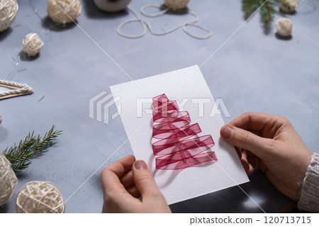 Christmas tree ribbon Storytelling of creating craft Christmas greeting card holiday present. Tactile hand-on activity. Master class progress of creative me-made gifts. Seasonal domestic life micro 120713715