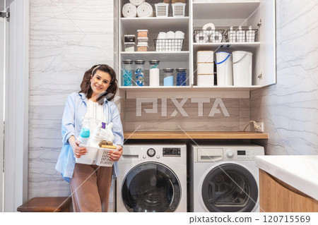 Woman housewife posing at modern white wooden bathroom laundry storage minimalism organizing 120715569