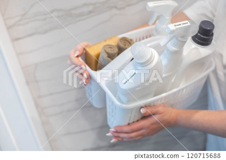 Woman housewife hands holding plastic container chemical detergent for bathroom laundry cleaning Woman housewife hands holding plastic container chemical detergent for bathroom laundry cleaning 120715688