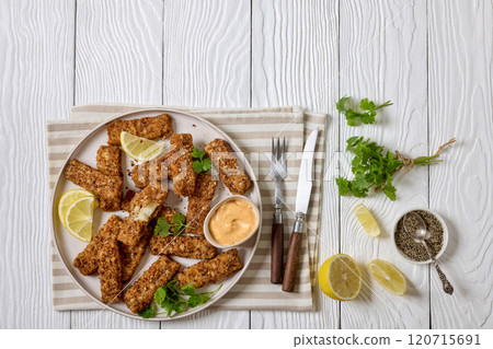 pretzel crusted fish sticks with lemon, mayo sauce 120715691