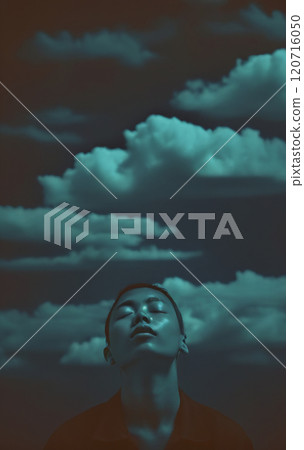 Conceptual depiction of a believing person, head turned towards heaven, radiating inner peace, calm equilibrium and hope 120716050