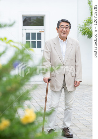 Senior man walking with a cane 120718285