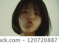 Japanese woman sticking out her tongue while looking down 120720887