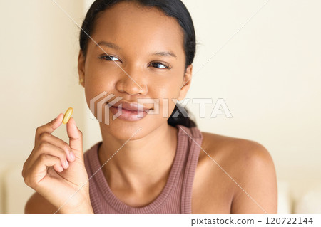 Woman Holding Vitamin Supplement, Embracing Wellness and Healthy Lifestyle Woman Holding Vitamin Supplement, Embracing Wellness and Healthy Lifestyle 120722144