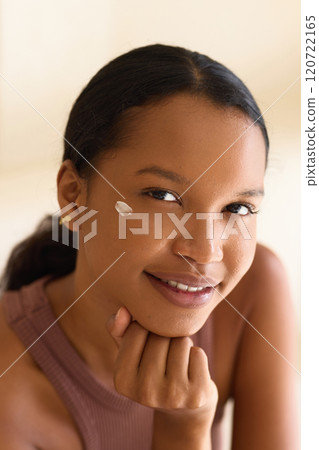 Skin Care Beauty.Young Woman Smiling With Cream on Cheek Experiencing Self-Care Skin Care Beauty.Young Woman Smiling With Cream on Cheek Experiencing Self-Care 120722165