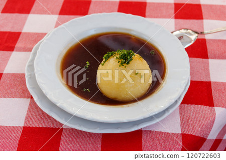 German potato dumpling in sauce on a table 120722603