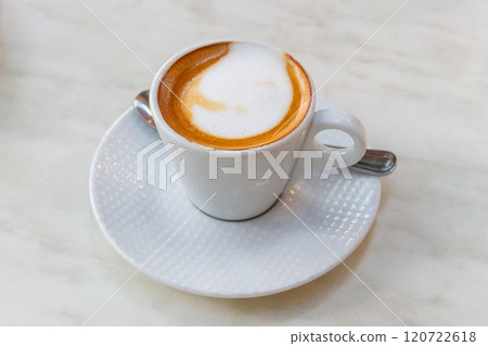Cup of hot cappuccino coffee on a table Cup of hot cappuccino coffee on a table 120722618