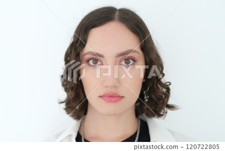 A captivating portrait of a Young Woman with curly hair against a clean white background A captivating portrait of a Young Woman with curly hair against a clean white background 120722805