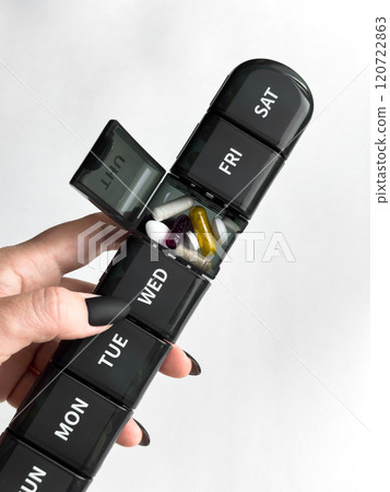 Weekly pill organizer with assorted medication Daily health management 120722863