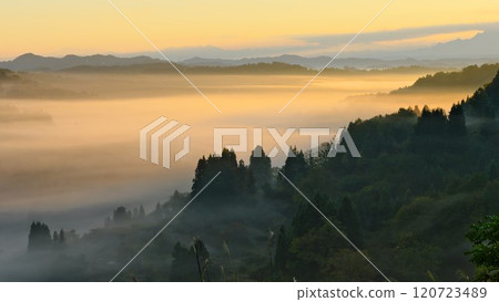 Morning mist hanging over Hoshi Pass in Tokamachi City. The morning sun creates a fantastic scene. Morning mist hanging over Hoshi Pass in Tokamachi City. The morning sun creates a fantastic scene. 120723489