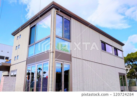 A newly built custom-built house that stands out against the blue sky A newly built custom-built house that stands out against the blue sky 120724284